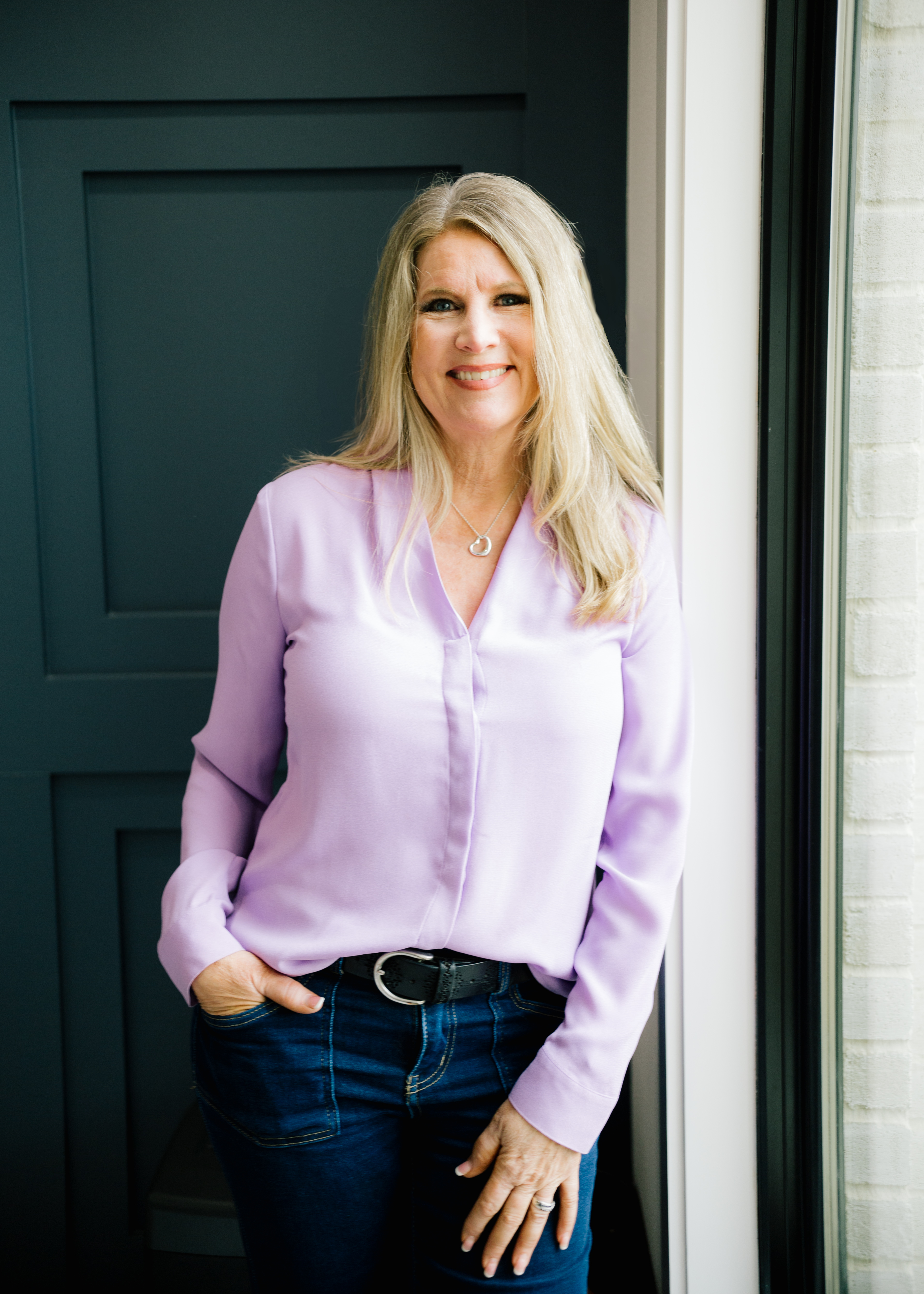 Dr. Victorya Rogers wearing a lavender blouse and jeans