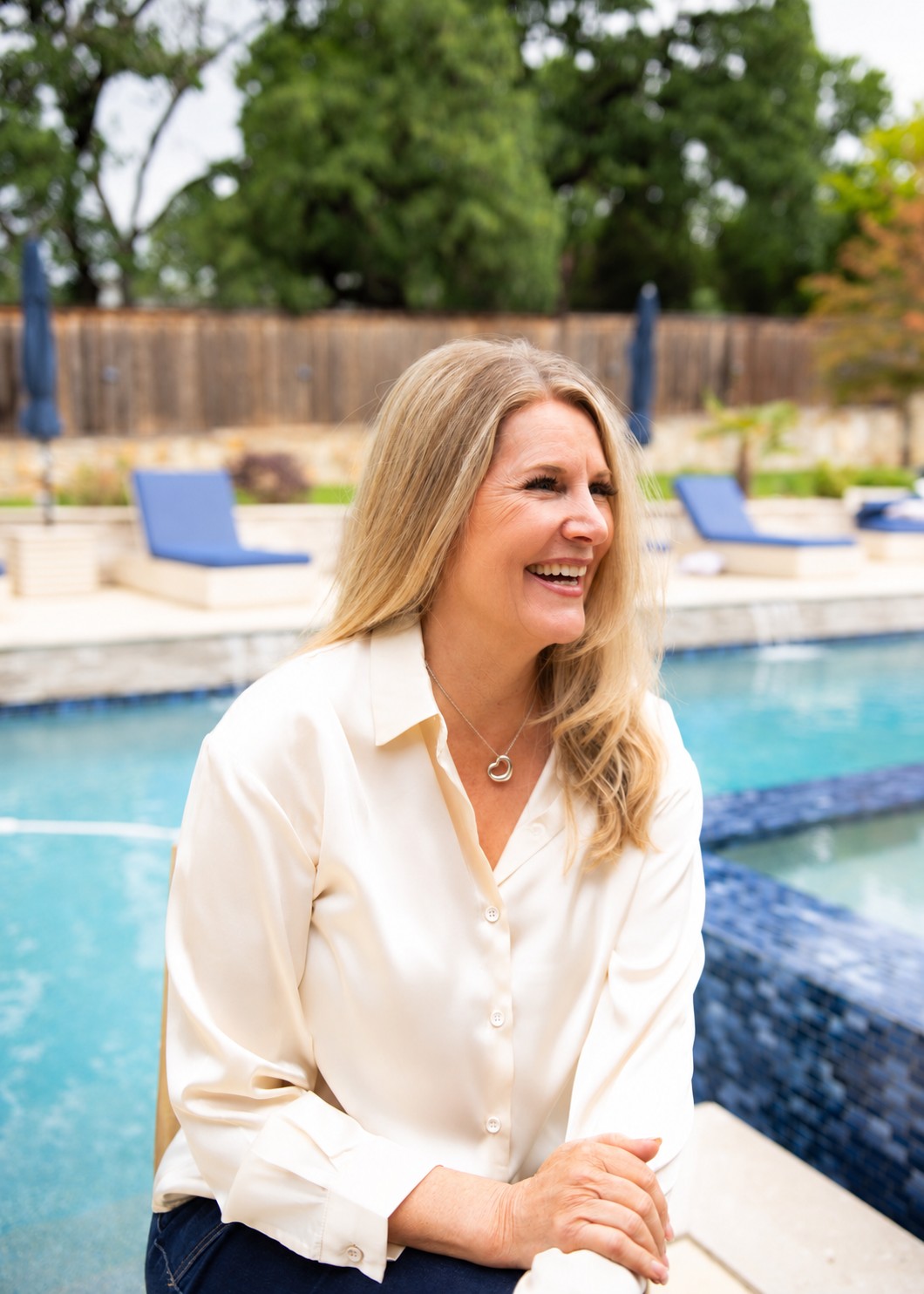 Dr. Victorya Rogers laughing beside a pool